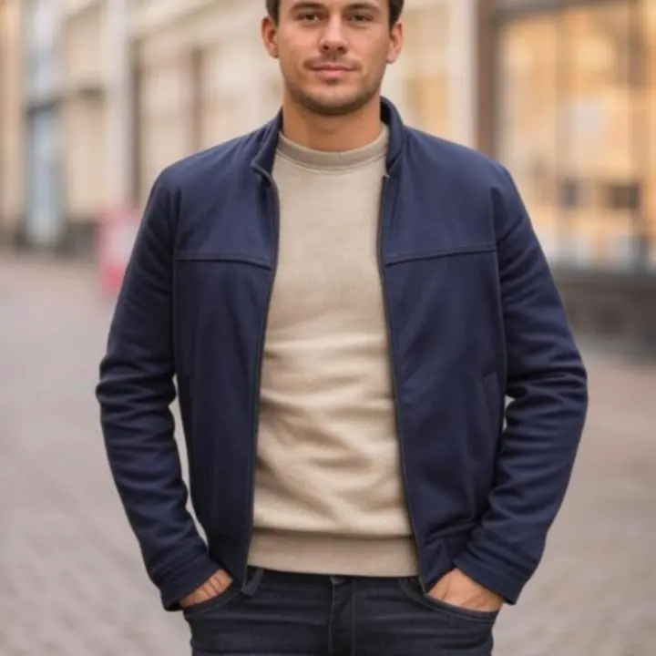 Model wearing refined casual menswear in an urban European setting